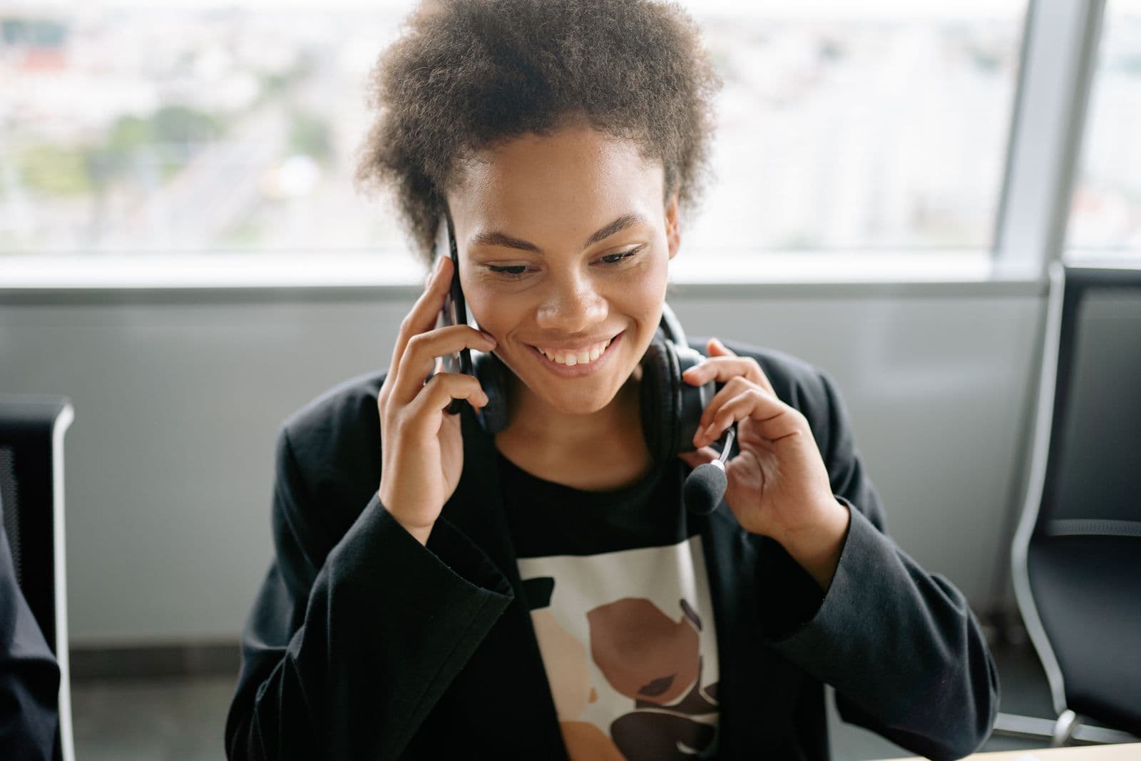 A client on a call, smiling at a desk
