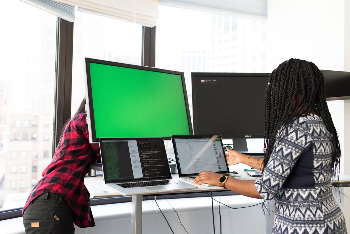 Two developers working side by side at their screens
